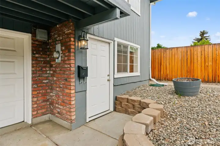 Entrance to additional dwelling unit to the left of the attached garage.
