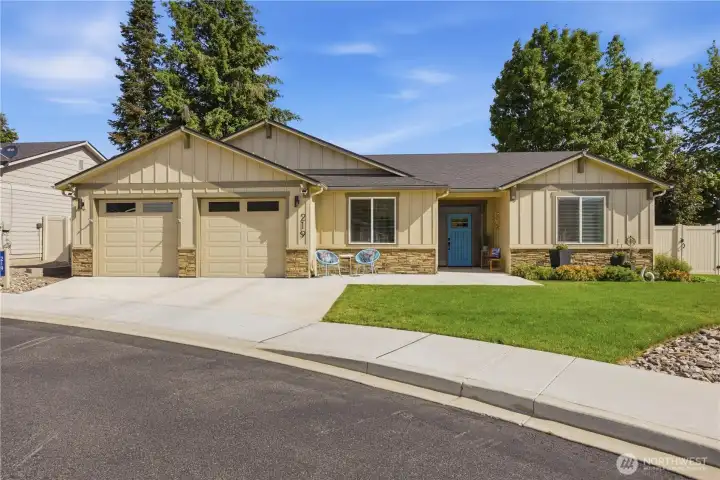 Stunning curb appeal on charming Pershing Circle featuring modern exterior finishes, manicured landscaping, paver accents, and welcoming front entry in one of Wenatchee’s most walkable neighborhoods.