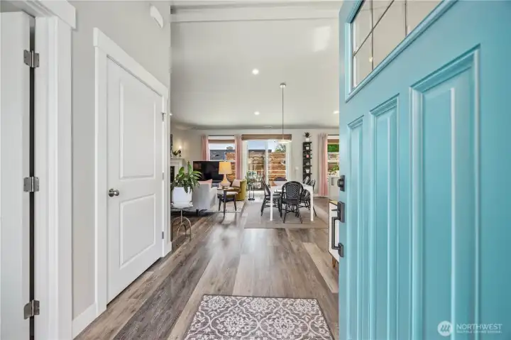 Grand entry with tall ceilings, luxury vinyl plank flooring, upgraded fixtures, and bright open sightlines creating a warm and welcoming first impression in this beautifully updated Wenatchee home.