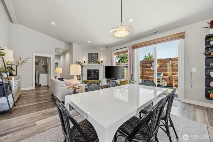 Open dining and living area with soaring ceilings, propane fireplace, and effortless flow for entertaining guests or relaxing evenings at home.