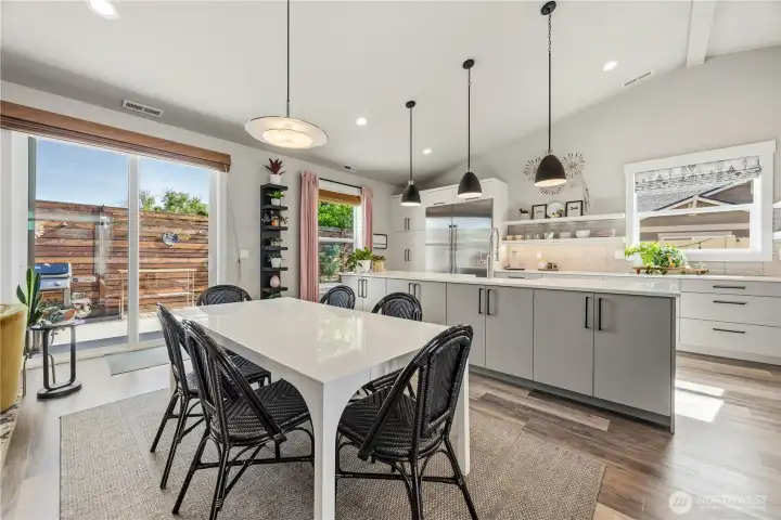 Spacious dining area connected seamlessly to the gourmet kitchen with oversized island, perfect for hosting gatherings and holiday meals.