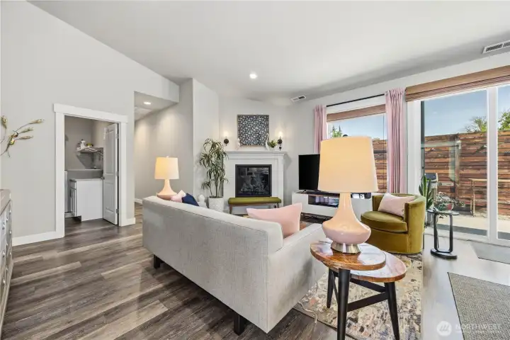 Cozy yet spacious living area designed for comfort with open sightlines, luxury flooring, and easy indoor/outdoor access.