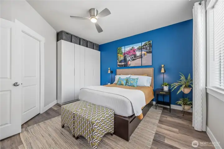 Spacious primary suite with LVP flooring, ceiling fan, and peaceful atmosphere designed for comfort and relaxation.