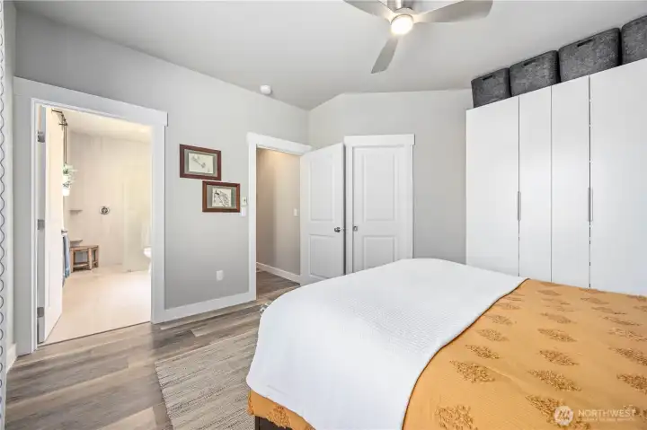Beautiful primary retreat featuring abundant natural light, custom built-in wardrobe storage, and easy access to spa-inspired ensuite bath.