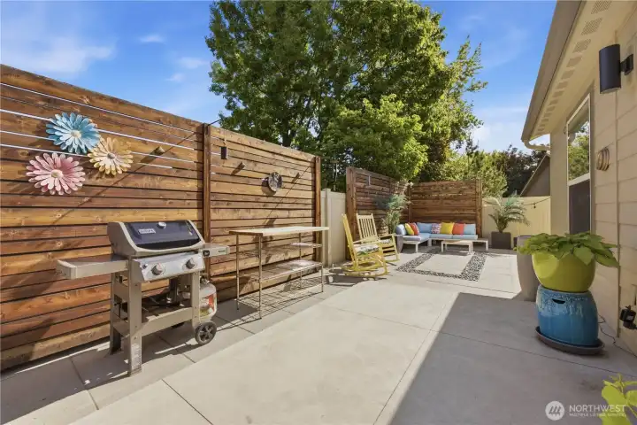 Private outdoor patio space with paver hardscape, privacy fencing, and ideal setup for outdoor dining and entertaining.