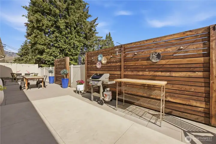 Extended entertaining patio complete with included outdoor furnishings, hardscape, and beautifully designed gathering spaces.