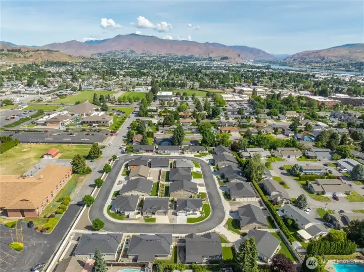 Aerial view showcasing desirable Pershing Circle location, charming one-way street setting, and close proximity to Wenatchee amenities and Saddlerock views.