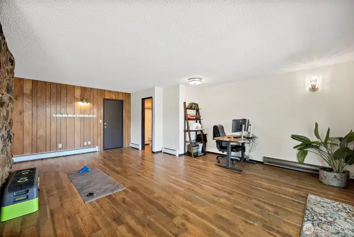 main living room with a wall of windows facing the lake