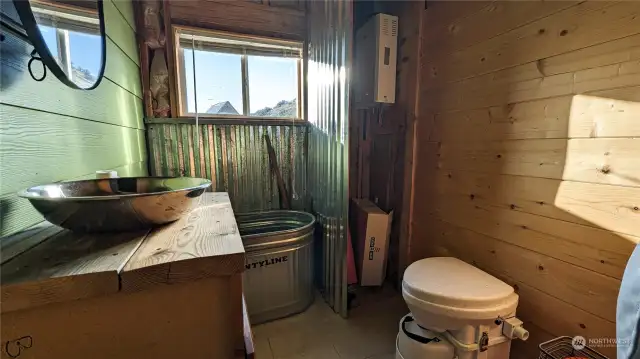 Bathroom with composting toilet and when water is hooked up there is a propane water heater.