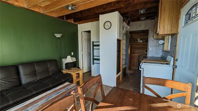 Door on left is to upstairs bedroom bathroom and mechanical room are right side back. Looking North.