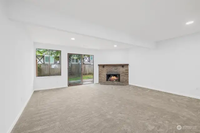 Large living room with fireplace and slider out to the patio area.