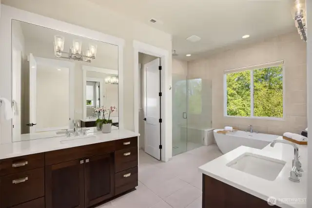 The primary bathroom with dual sinks, an over-sized shower and soaking tub.