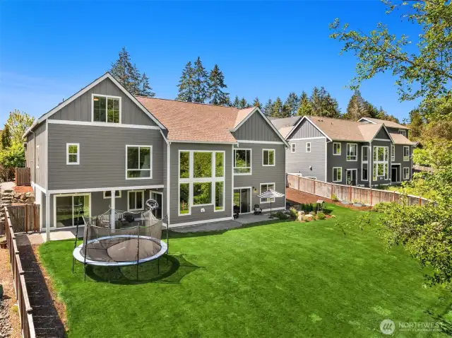 A aerial look at the grassy area in the fenced backyard.