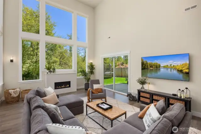 The great room with the dining area and kitchen flow easily to the outdoors through multiple doors.