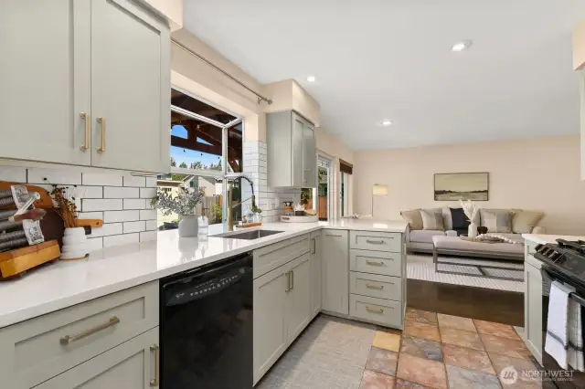 Quartz counters, modern cabinetry, and a great garden window.
