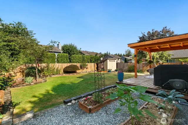 Raised garden beds and functional storage shed.