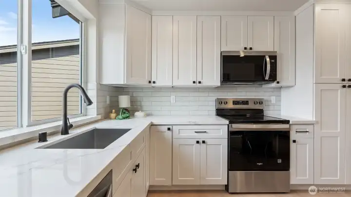 Farm sink in kitchen located under the window gives so much light.