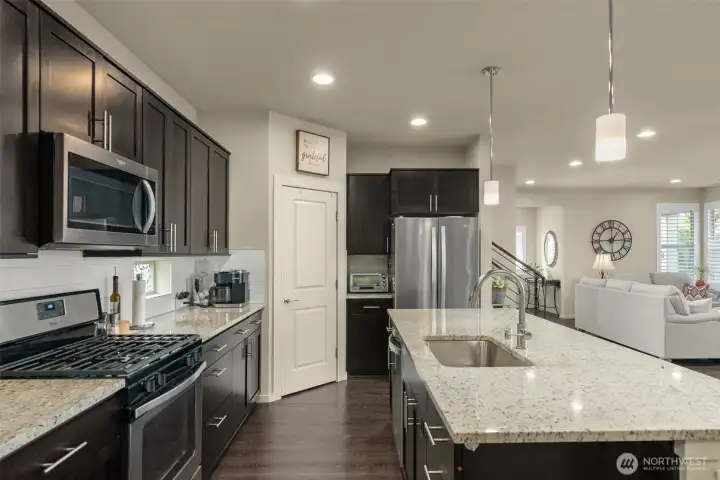 Kitchen with slab countertops and stainless appliances