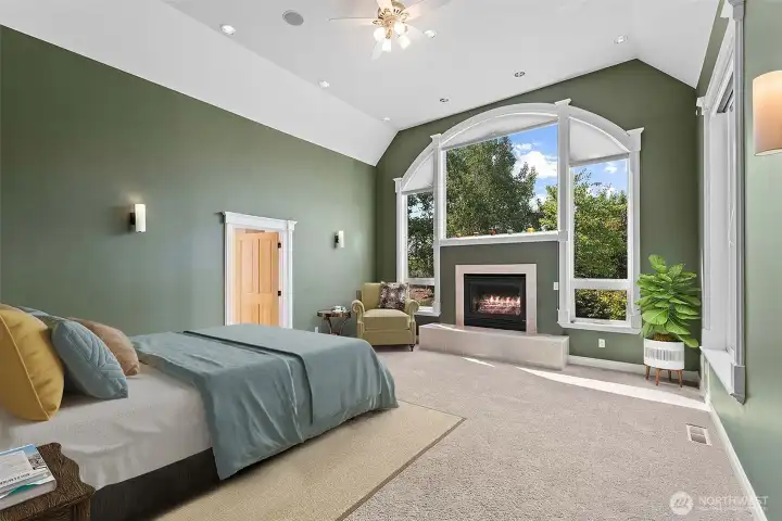 A fireplace, and a striking arched window that creates a bright and relaxing retreat.