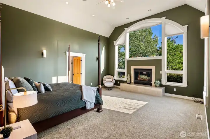 A fireplace, and a striking arched window that creates a bright and relaxing retreat.