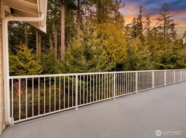Overlooking a lush native forest of evergreens, the private deck offers a peaceful, natural backdrop and serves as the inspiration behind the home’s custom mural.