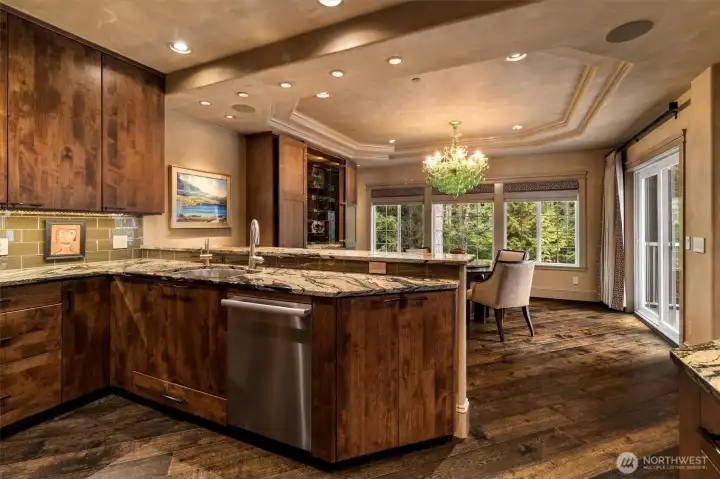 Seamless connection between the kitchen and dining area is enhanced by an abundance of natural light, creating a bright and inviting space.