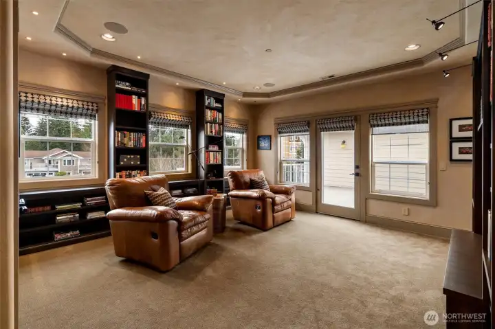 Currently used as a media room, this versatile space features custom Roman blackout shades for a true cinematic experience and can easily transition into guest quarters, a home office, or whatever fits your lifestyle.