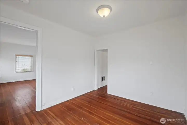 Bedroom 2 with wooden flooring.