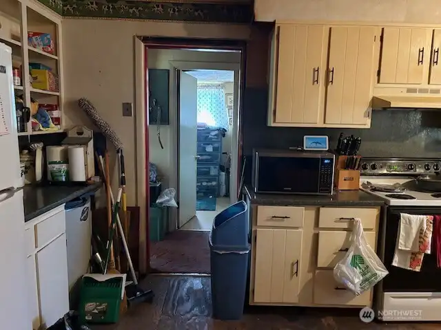 Kitchen looking toward hallway and bathroom