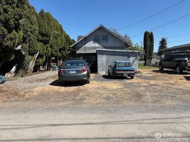 View of the back of the property from the alley.  Enclosed shed is large enough for a car.