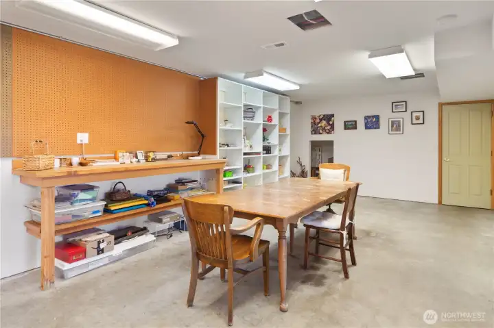 Unfinished space in the daylight basement creates an ideal craft/work room.