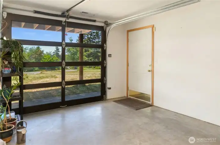 Daylight basement features glass garage door to bring the outside in.