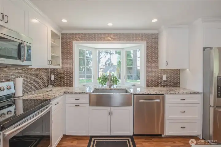Farmhouse sink, abundant prep space, and backyard views make this kitchen a joy to cook in. Farmhouse sink, abundant prep space, and backyard views make this kitchen a joy to cook in.