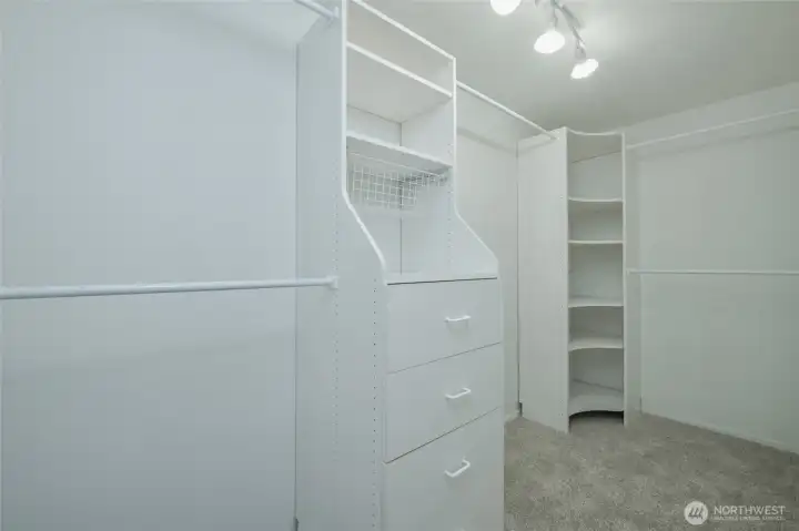 Generous custom walk-in closet keeps everything organized Generous custom walk-in closet keeps everything organized