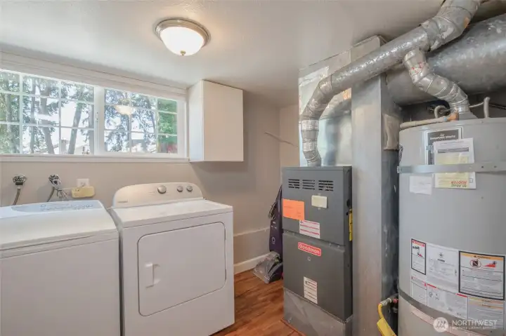 Dedicated laundry room with updated mechanical systems and additional storage Dedicated laundry room with updated mechanical systems and additional storage