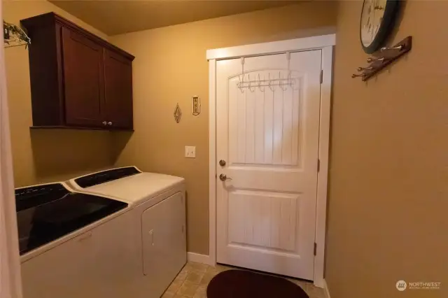 Step into the utility room from the two car garage and proceed into the hallway.