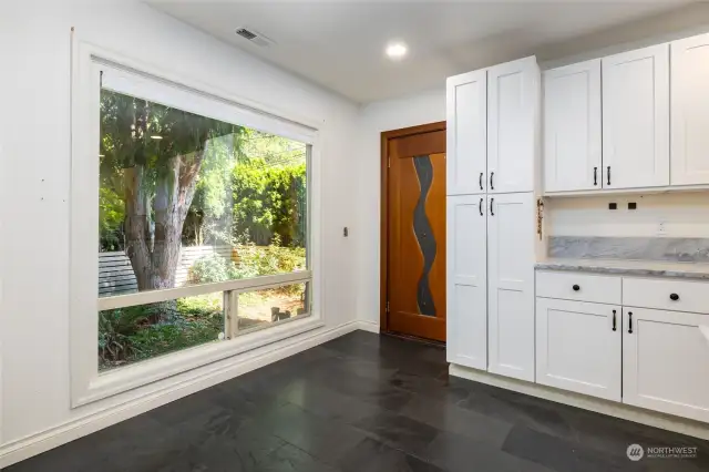 Beautiful custom door opens up to the elevator taking you upstairs.