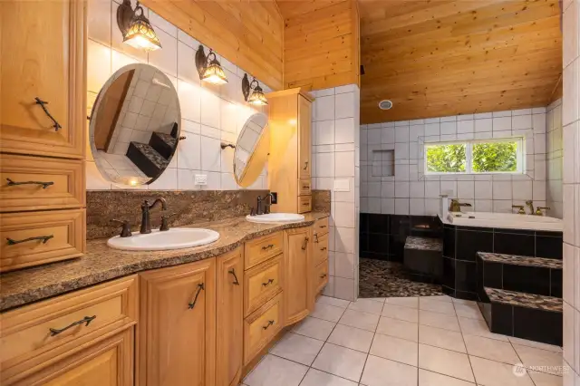 Upstairs primary bathroom is just off the primary bedroom with double sinks and a large soaking tub plus a shower.