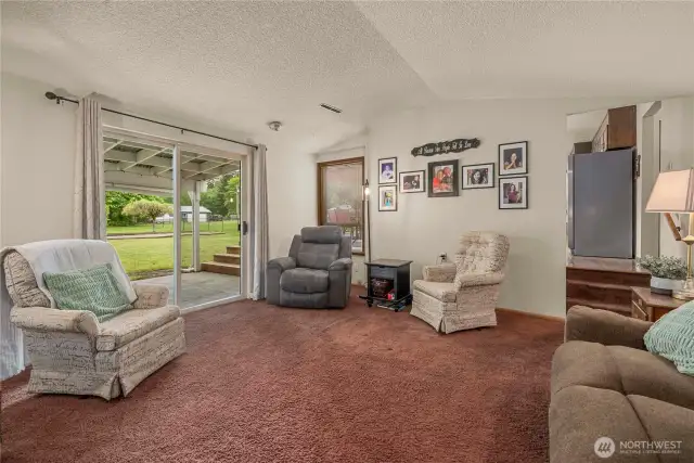 2nd Living room with sliding door to back patio and three steps up to the kitchen
