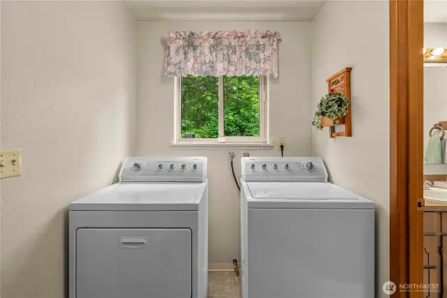Laundry room with linen closet and access to garage on left