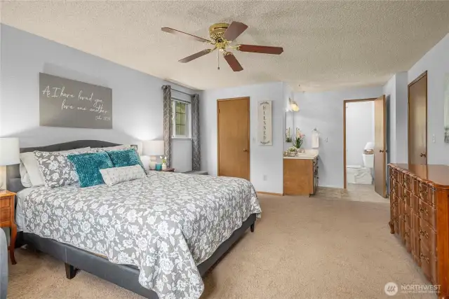 Window overlooking RV parking on the side of the house, large walk-in closet, and attached private bath