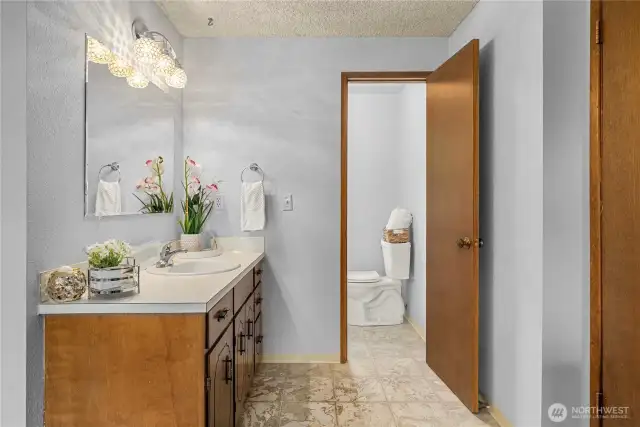 Bathroom sink and vanity separated from the shower/toilet allows multiple people to get ready simultaneously