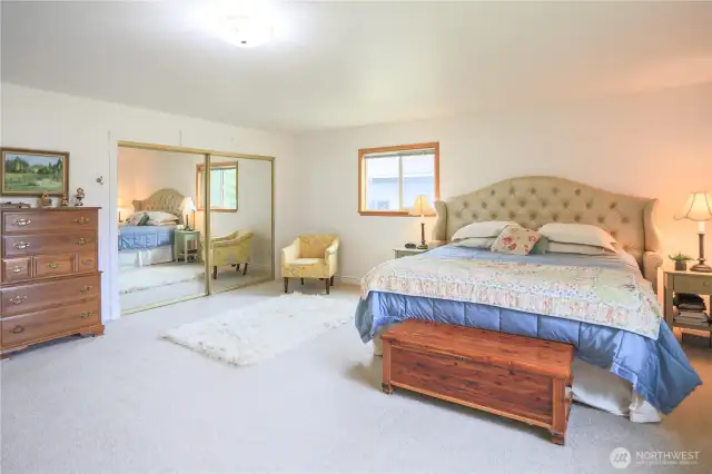 There is ample space in the primary bedroom to accommodate a king-size bed, as well as dresser(s), side table(s), and even more...