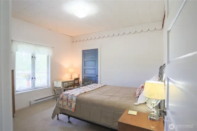Other view showing this bedroom looks out on the back porch and pastures.