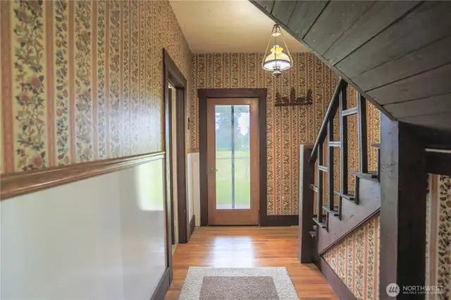 The nostalgic back entry, with its unique character, leads to the back porch, then upstairs to the finished attic space ready for your home office or den, making this a great combination of vintage and updated charm.