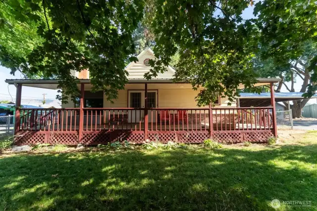 Front yard of Home has covered front porch. French doors open this homes front door to Living room.  Nice yard with U.G. sprinkler system.