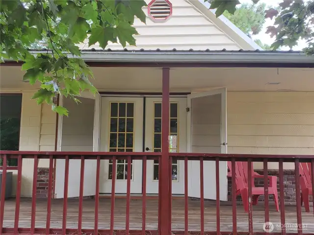 Covered front porch has solid wood deck and railing. Screen double doors open to French door open homes entrance.   Enjoy the canopied tree front yard under cover all seasons.