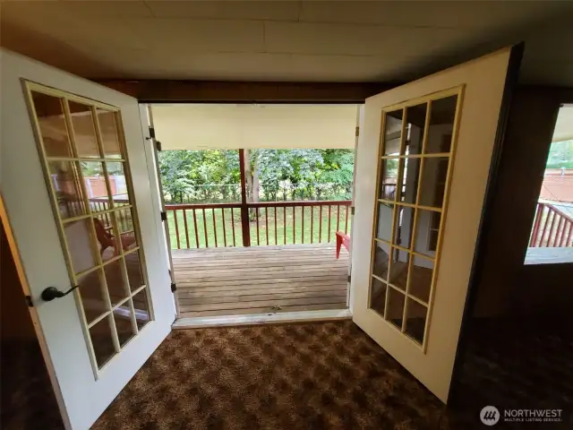 Double French doors open to Living room of this home from covered porch.