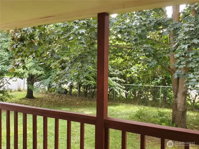 Front yard from covered deck is established grass-yard with underground sprinkler system. Large trees offer cool shade, privacy and lush green setting.