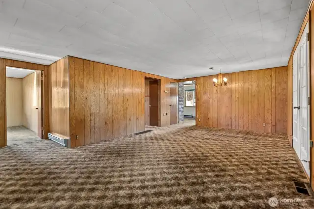 Spacious Living room and dining room area is carpeted.